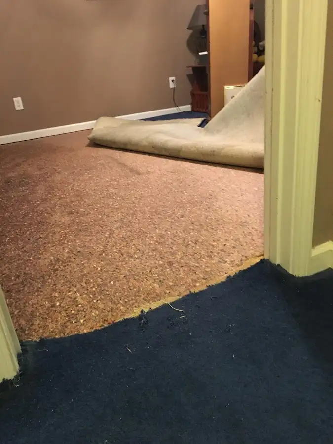 Carpet pad removal revealing water damage during Drying & Dehumidification in Winder